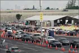  ?? (AP/Lynne Sladky) ?? Vehicles form a line Monday at the covid-19 testing site at Hard Rock Stadium in Miami Gardens,
Fla.