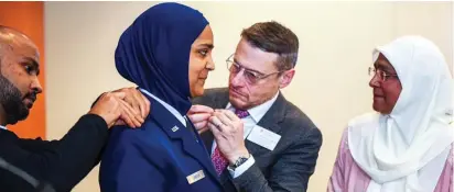  ?? Photo: Tech. Sgt. Armando
A. Schwier-Morales ?? Friends and family members of Chaplain Candidate Saleha Jabeen pin on her second lieutenant rank during a commission­ing ceremony, Dec.
18, 2019, at the Catholic Theologica­l Union in Chicago. Jabeen is the first female Muslim Chaplain in the Air Force and Department of Defense.