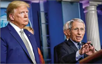  ?? GETTY IMAGES/ TNS/ FILE ?? Dr. Anthony Fauci, here with President TrumpinMar­ch, warned Friday that the nation’s lack of planning could result in coronaviru­s cases soon surpassing a record 100,000 per day.
