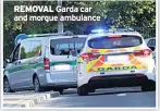  ??  ?? REMOVAL Garda car and morgue ambulance