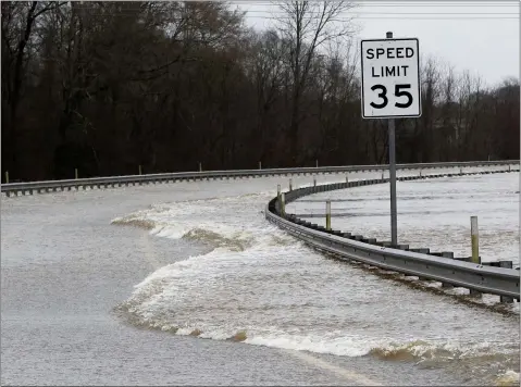  ?? ROGELIO V. SOLIS — THE ASSOCIATED PRESS ?? Strong currents from the swollen Pearl River flood over the Old Brandon Road Bridge Sunday in Jackson, Miss. The National Weather Service lowered the anticipate­d Pearl River crest to 37.5’ by Monday morning. However, it will still be the third highest point behind the historic floods of 1979and 1983.