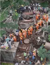  ?? PTI ?? Fire brigade and NDRF personnel carrying out a search and rescue operation following a building collapse at Ghatkopar in Mumbai on Tuesday. —