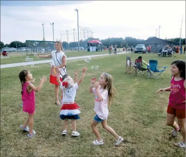  ?? File Photo/Westside Eagle Observer/SUSAN HOLLAND ?? Children play with bubbles July 2 at Pop Allum Park in Gravette. The city is expected to receive almost $409,000 in federal money for a trail project that will connect Pop Allum Park with local schools.