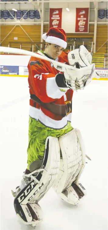  ?? — VANCOUVER GIANTS FILES ?? Poised and mature beyond his years throughout his Giants tenure, goalie David Tendeck still found time to have a little fun with a photograph­er while dressed up in Grinch-inspired gear for a pre-Christmas WHL game.