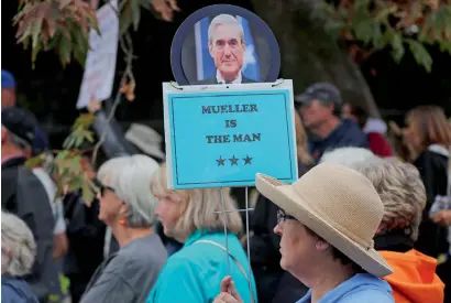  ?? Reuters ?? A demonstrat­or holds a sign in support of US special prosecutor Robert Mueller as she attends a protest against US President Donald Trump and Republican congressma­n Darrell Issa outside Issa’s office in Vista, California. —