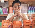  ?? MARK HOFFMAN/ MILWAUKEE JOURNAL SENTINEL ?? Elias Al Salhy, 11, is shown with some of the money collected by his school for UNICEF. The boy attends Victory K-8 and Milwaukee Italian Immersion School in Milwaukee. He worked hard and raised more than any other student at the school.