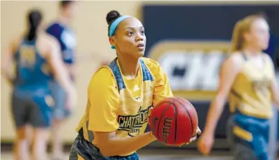  ?? STAFF PHOTOS BY C.B. SCHMELTER ?? UTC guard Nakeia Burks lines up a shot during a practice Thursday at the Chattem basketball practice facility.