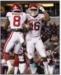  ?? (AP/Sam Craft) ?? Arkansas wide receiver Treylon Burks (16) celebrates with Mike Woods after scoring a touchdown against Texas A&M on Saturday night.