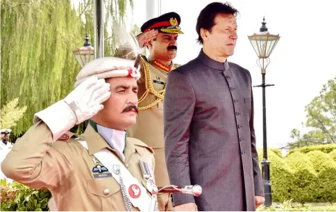  ?? — AFP photo ?? Handout photograph shows Imran Khan inspects guard of honour on his arrival in the Prime Minister House during a ceremony in Islamabad.