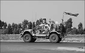  ??  ?? A US military vehicle arrives near Dahuk, Iraq, on Monday after pulling out of northern Syria.
(Photo: Al Jazeera)