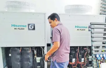  ?? Picture: SUPPLIED. ?? Left: Hisense installati­on of VRF units at Hilton Fiji Beach Resort & Spa by Courts service technician.