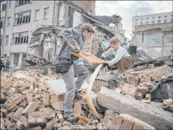  ?? Efrem Lukatsky
The Associated Press ?? Volunteers and students of Kyiv State Arts Academy clear rubble after the Academy was partly ruined during the Russian missile attack this week in Kyiv, Ukraine.