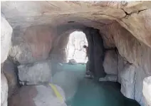  ??  ?? A golfer putts through a grotto at Boomers! Boca Raton.