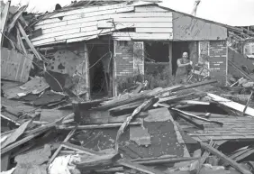  ?? RONALD W. ERDRICH/USA TODAY NETWORK ?? A resident picks through the debris of a home Saturday in Abilene, Texas, after a possible tornado hit the neighborho­od.