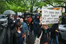  ?? Craig Hudson/The Washington Post ?? Abortion-rights activists protest May 7 outside Supreme Court Justice Brett Kavanaugh’s home in Chevy Chase, Md.