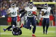  ?? JULIO CORTEZ — THE ASSOCIATED PRESS ?? Tennessee Titans running back Derrick Henry (22) runs past Baltimore Ravens strong safety Chuck Clark (36) during the second half of an NFL divisional playoff football game, Saturday, Jan. 11, 2020, in Baltimore.