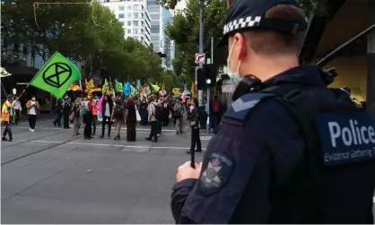  ?? ?? Police observe a climate protest in Melbourne. Legal and environmen­tal groups say activists are facing increasing repression from Australian government­s. Photograph: Mikko Robles/NurPhoto/REX/Shuttersto­ck