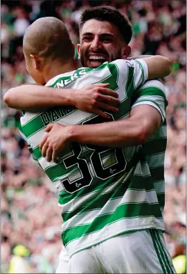  ?? ?? Greg Taylor and Daizen Maeda embrace in celebratio­n after Jota’s goal put the Parkhead side ahead in yesterday’s derby
