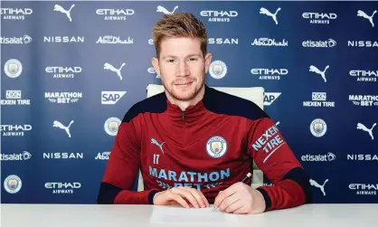  ??  ?? Kevin De Bruyne signs the deal that is due to keep him at Manchester City until 2025. ‘This football club is geared for success,’ he said. Photograph: MCFC