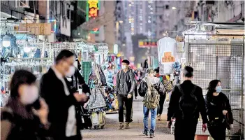  ??  ?? Pedestrian­s walk past street market stalls in the Sham Shui Po district of Kowloon in Hong Kong, one of the internatio­nal business hub’s poorest districts.