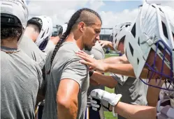  ?? PETE KIEHART/NEW YORK TIMES ?? The Haudenosau­nee Nationals men’s lacrosse team huddles around Jeremy Thompson on July 11 at the World Games in Birmingham, Ala.