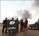  ?? SAFIN HAMED/AFP ?? Iraqi forces hold an Islamic State flag in Qayyarah on August 30.