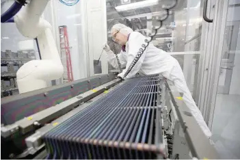  ?? — Reuters ?? A production operator is seen at work at the Solarworld solar panel factory in Hillsboro, Oregon, US.