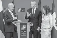  ?? Olivier Matthys/associated Press ?? Finland’s Foreign Minister Pekka Haavisto, left, Ann Linde, Sweden’s foreign minister, and NATO Secretary General Jens Stoltenber­g talk after accession protocols were approved.