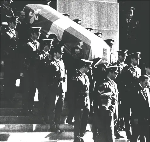  ?? Ra y Ryder / Montreal Gazett e files ?? Pierre Laporte’s coffin is led outside at his funeral on Oct. 20, 1970. The Quebec deputy premier was kidnapped and killed during the October Crisis.