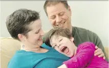  ??  JULIE OLIVER/OTTAWA CITIZEN ?? Julie Keon is pictured with her husband, Tim Graham, and their daughter, Meredith, 11. Keon has written a book about caring for Meredith, who has cerebral palsy.