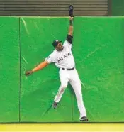  ?? MICHAEL REAVES/GETTY IMAGES MICHAEL REAVES/GETTY IMAGES ?? Lewis Brinson snatched away Mookie Betts’ bid for a home run in the 11th inning against the Red Sox on Tuesday.