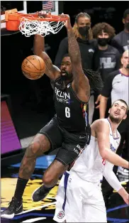  ?? SARAH STIER — GETTY IMAGES ?? The Brooklyn Nets’ DeAndre Jordan (6) dunks as the Los Angeles Clippers’ Ivica Zubac looks on during the first half a Feb. 2 game at Barclays Center in New York.