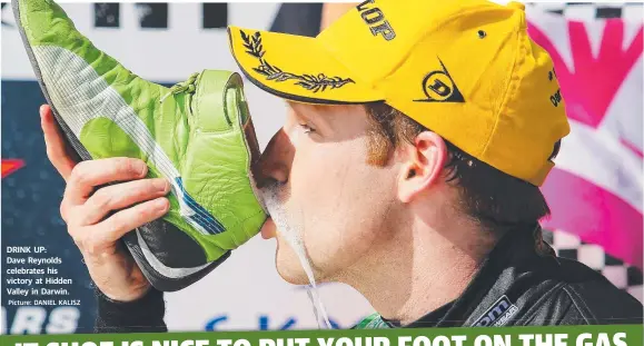  ?? Picture: DANIEL KALISZ ?? DRINK UP: Dave Reynolds celebrates his victory at Hidden Valley in Darwin.