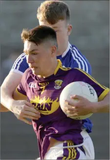  ??  ?? Wexford captain Ciarán Kavanagh is tackled by Seán Michael Corcoran of Laois during Wednesday’s encounter.