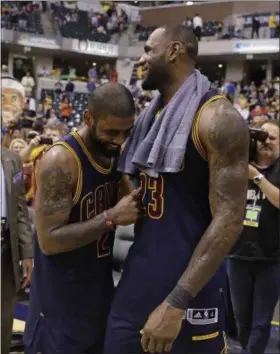  ?? DARRON CUMMINGS — ASSOCIATED PRESS ?? The Cavaliers’ LeBron James and Kyrie Irving celebrate after Cleveland defeated the Pacers, 106‑102, to win Game 4 of their first‑round playoff series on April 23.