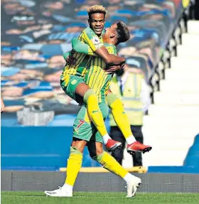  ??  ?? Off the mark: Grady Diangana (left) is congratula­ted by Callum Robinson after giving West Brom the lead at Everton last weekend in their 5-2 defeat