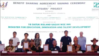  ?? ?? Sagah (standing third right) and Jaul (seated centre) pose with representa­tives of the communitie­s and others after the signing ceremony yesterday.