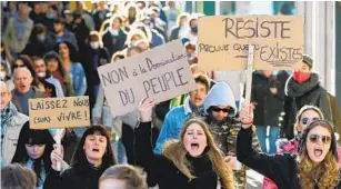  ?? BOB EDME AP ?? Demonstrat­ors hold placards that read “No to the domination of the people” and “Resist” as they protest in Bayonne, France, on Saturday.