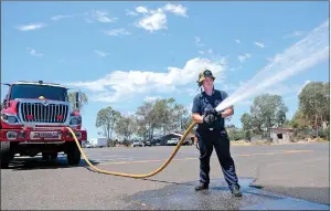  ??  ?? CalFire Forest Ranch Firefighte­r Matt Aldrich works a hose while training on Monday.