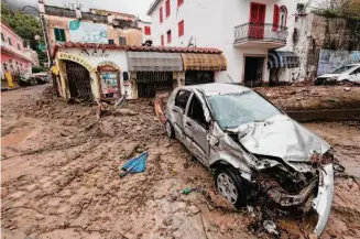  ?? Alessandro Garofalo/LaPresse ?? Mud and debris fill streets after heavy rainfall caused a landslide that collapsed buildings and mangled vehicles in the port city of Casamiccio­la on the southern Italian island of Ischia.