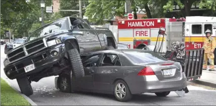  ?? JOHN RENNISON, THE HAMILTON SPECTATOR ?? The scene at Queen Street South at Herkimer after a stolen pickup truck hauling a trailer of landscapin­g equipment was pursued down a Mountain access.