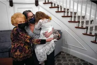  ?? Steven Senne / Associated Press ?? Gloria Winston, 94, a resident at Laurelmead Cooperativ­e community in Providence, R.I., hugs her great-niece Wensday Greenbaum and 5-year-old great-great-niece Cordelia Cappelano.