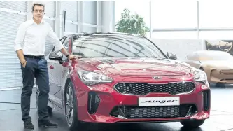  ?? HANDOUT/KIA ?? Gregory Guillaume, the design chief at Kia Design Center Europe in Frankfurt, Germany, stands beside the Kia Stinger.