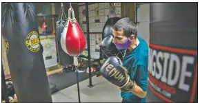  ??  ?? When not hitting the bags in the gym, Alex Mazzarisi, hits the books for classes at Sauk Valley College in Dixon, Ill.