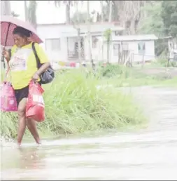  ??  ?? ooded street last month after heavy rain. (SN file photo)