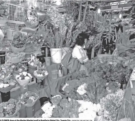  ?? JUNPINZON | DREAMSTIME.COM ?? A FLOWER shop at the Market Market mall in Bonifacio Global City, Taguig City.