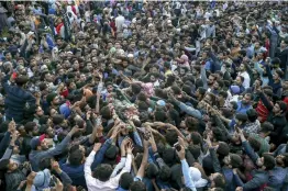  ?? — AP ?? Kashmiri men carry the body of Dawood Salafi, a local rebel commander, during his funeral on the outskirts of Srinagar on Friday. At least four rebels, a counterins­urgency police official and a civilian were killed during a gunbattle in Kashmir on...