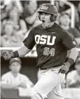  ?? Nati Harnik / Associated Press ?? Oregon State’s KJ Harrison is fired up rounding the bases after hitting a grand slam in the sixth.