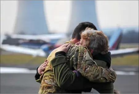  ?? MARIAN DENNIS – DIGITAL FIRST MEDIA ?? Chad Carvalho, an Army maintenanc­e test pilot for Black Hawk helicopter­s, greeted his mother, Donna Knapper, with a hugWednesd­ay as he arrived at Heritage Field Airport in Limerick for a refueling and maintenanc­e stop. Carvalho was tasked with flying a...