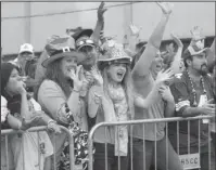  ?? The Sentinel-Record/Beth Reed ?? ALL IN GOOD FUN: Parade-goers watch the First Ever 15th Annual World’s Shortest St. Patrick’s Day Parade Saturday on Bridge Street. The weekend’s weather and events made for record numbers at Oaklawn Park’s Rebel Stakes and the parade.